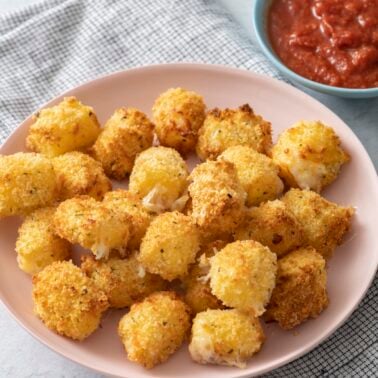 Air fryer crispy cheese bites on a plate.