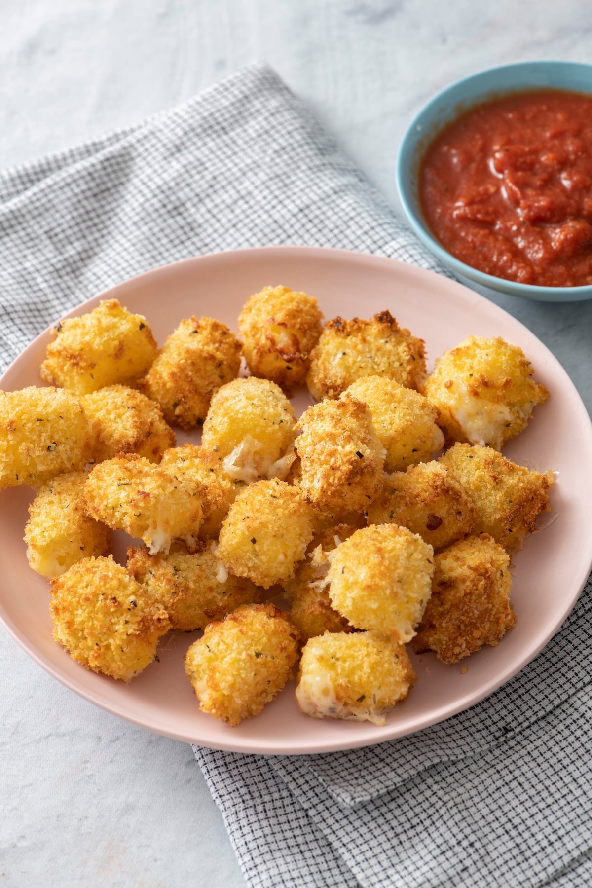 Air fryer crispy cheese bites on a plate.