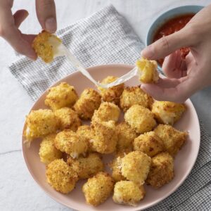 Crispy cheese bites on a plate.