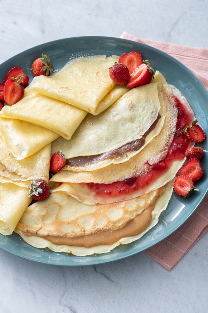 Three crepes filled with nutella, strawberry jam and peanut butter.