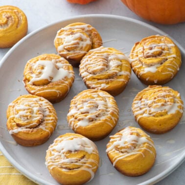 Quick pumpkin cinnamon rolls on a plate.