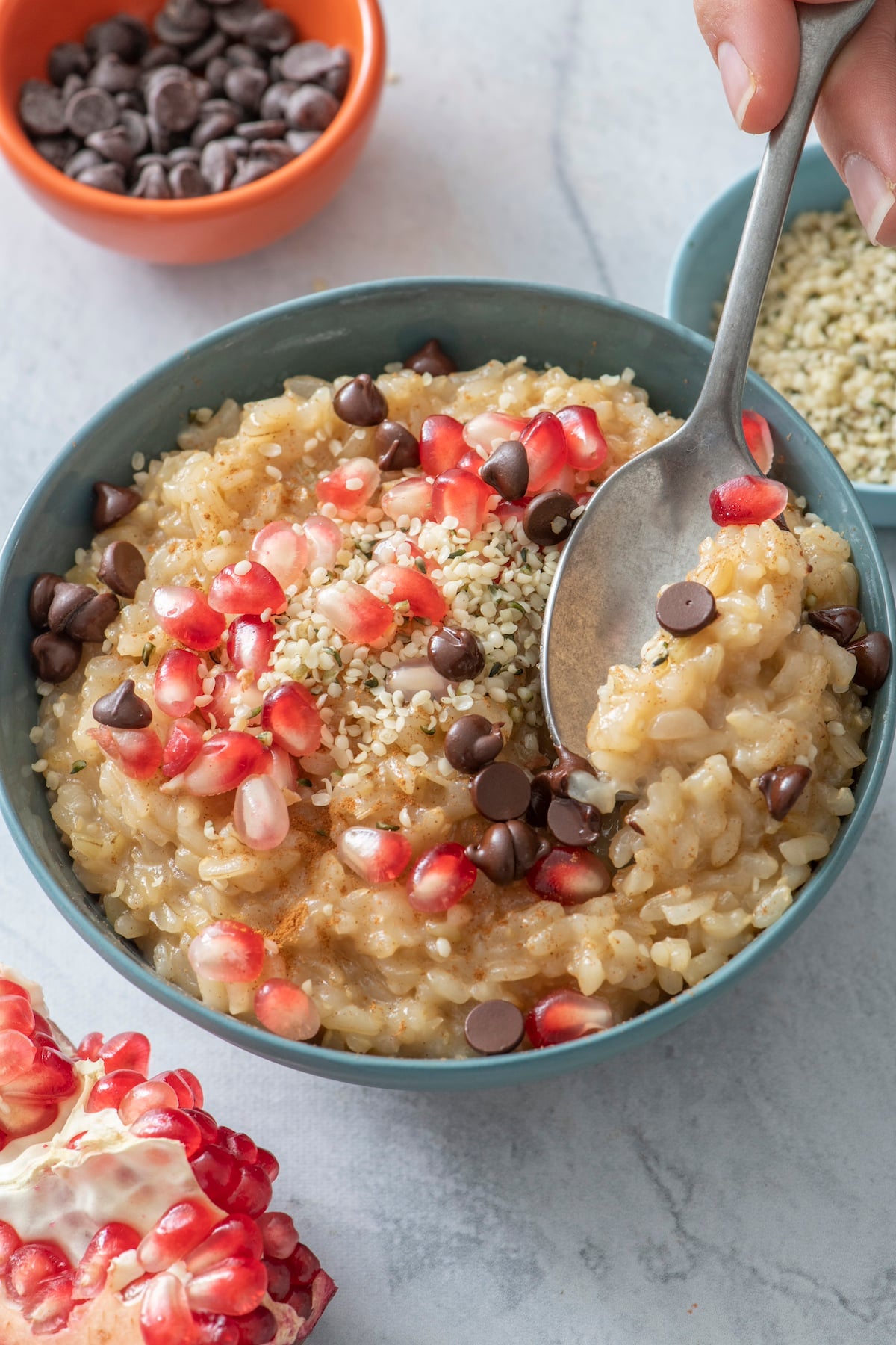 Leftover Rice Pudding topped with chocolate chips and pomegranate seeds.