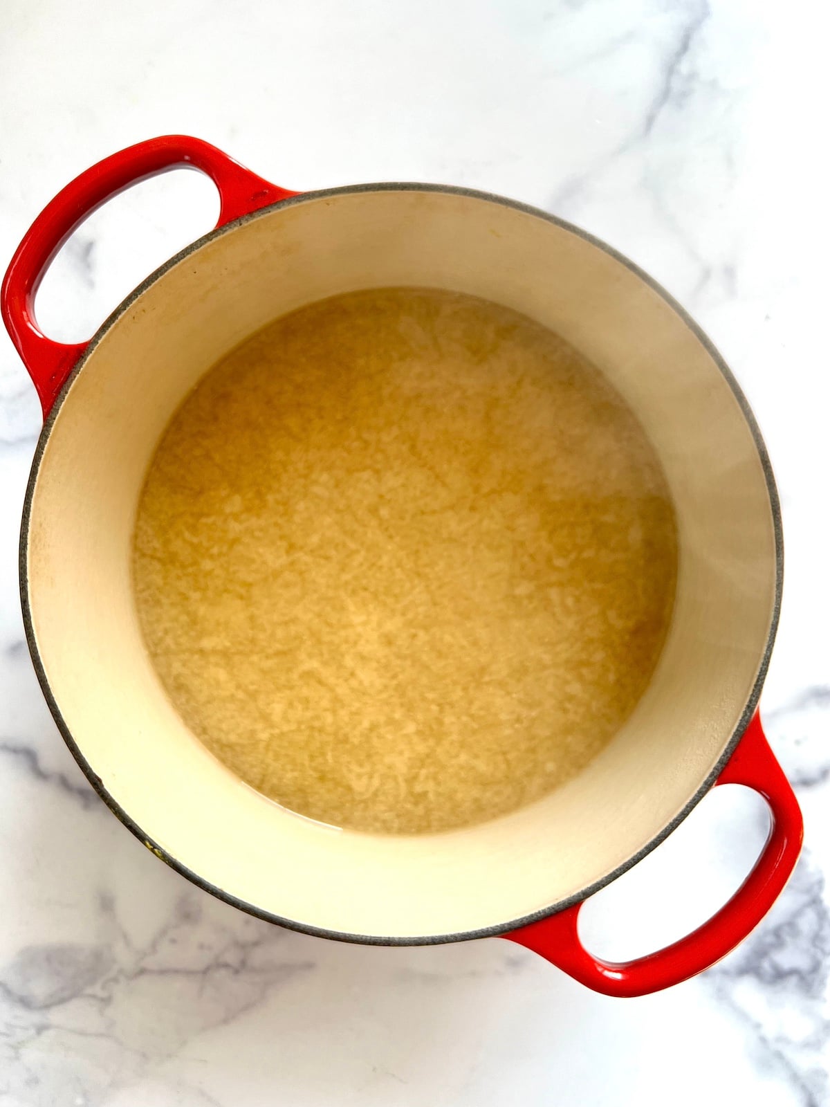 Ramen noodle soup broth in sauce pan.