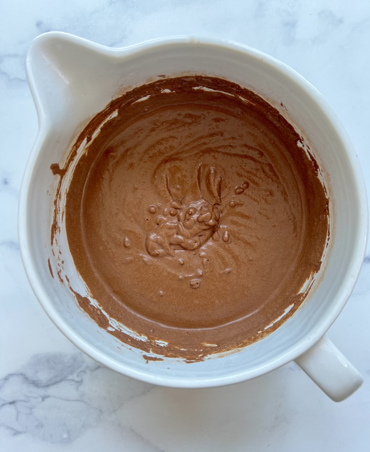 Dairy free chocolate ice cream mixture in bowl.