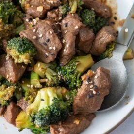 Beef and broccoli stir fry on white serving platter.