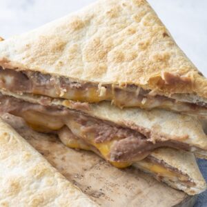 Tortilla pillows on a cutting board.