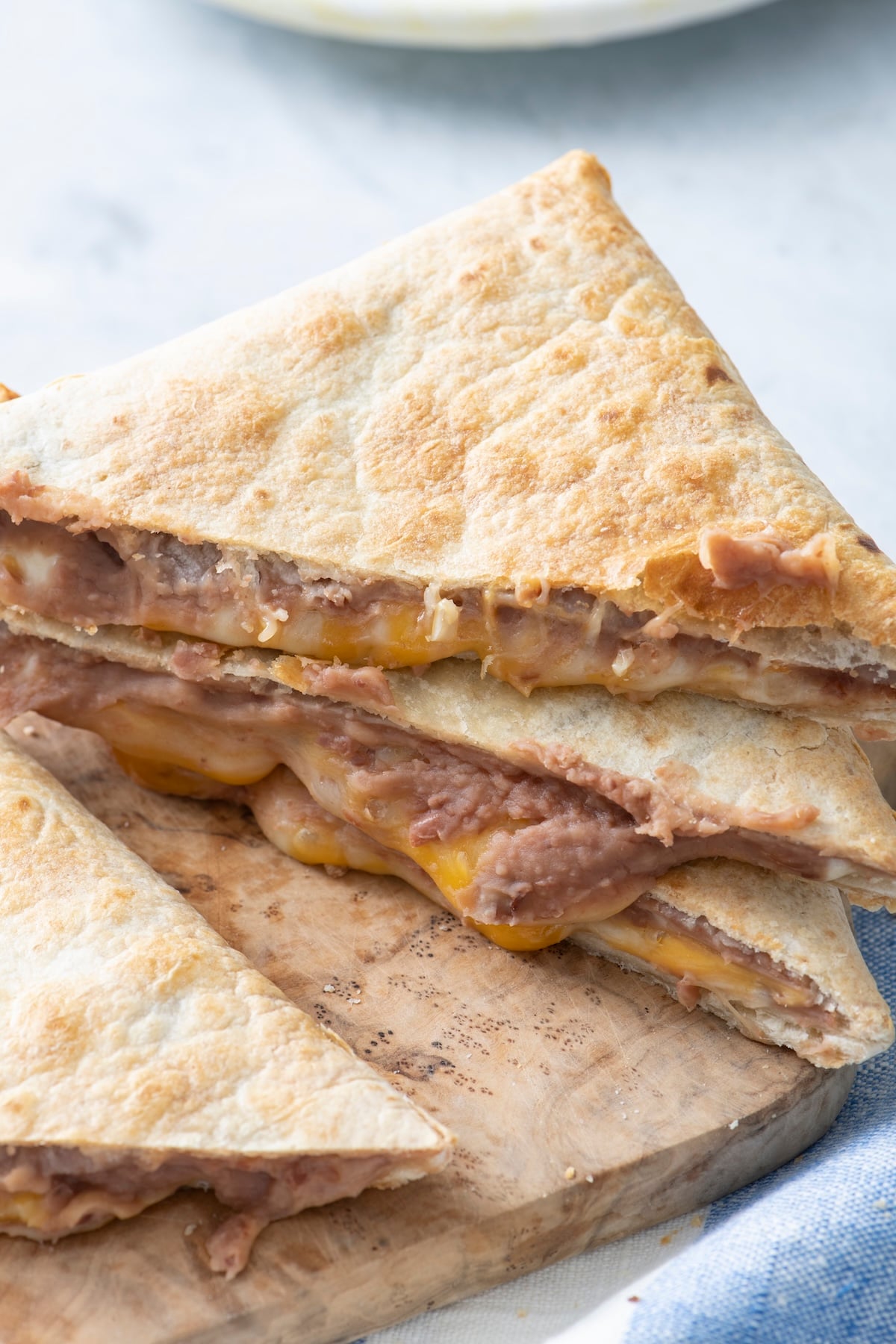 Tortilla pillows on a cutting board.