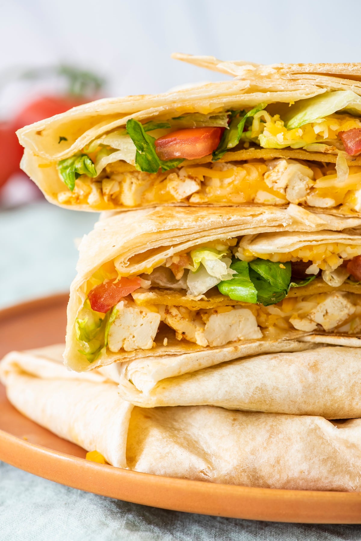Stack of vegetarian crunchwrap supremes on a plate.