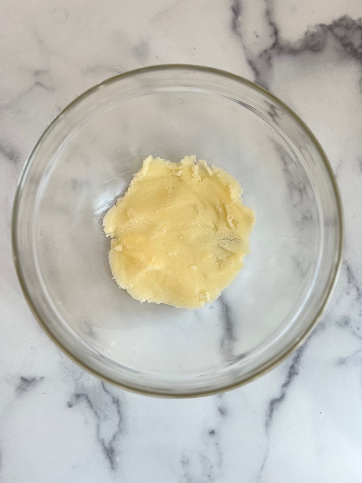 Butter and sugar creamed together in a mixing bowl.