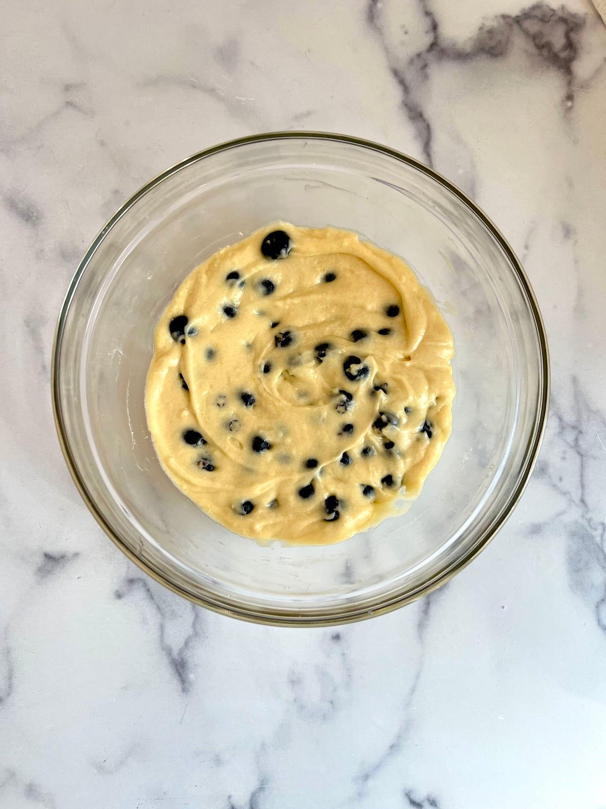Blueberry doughnut batter in mixing bowl.