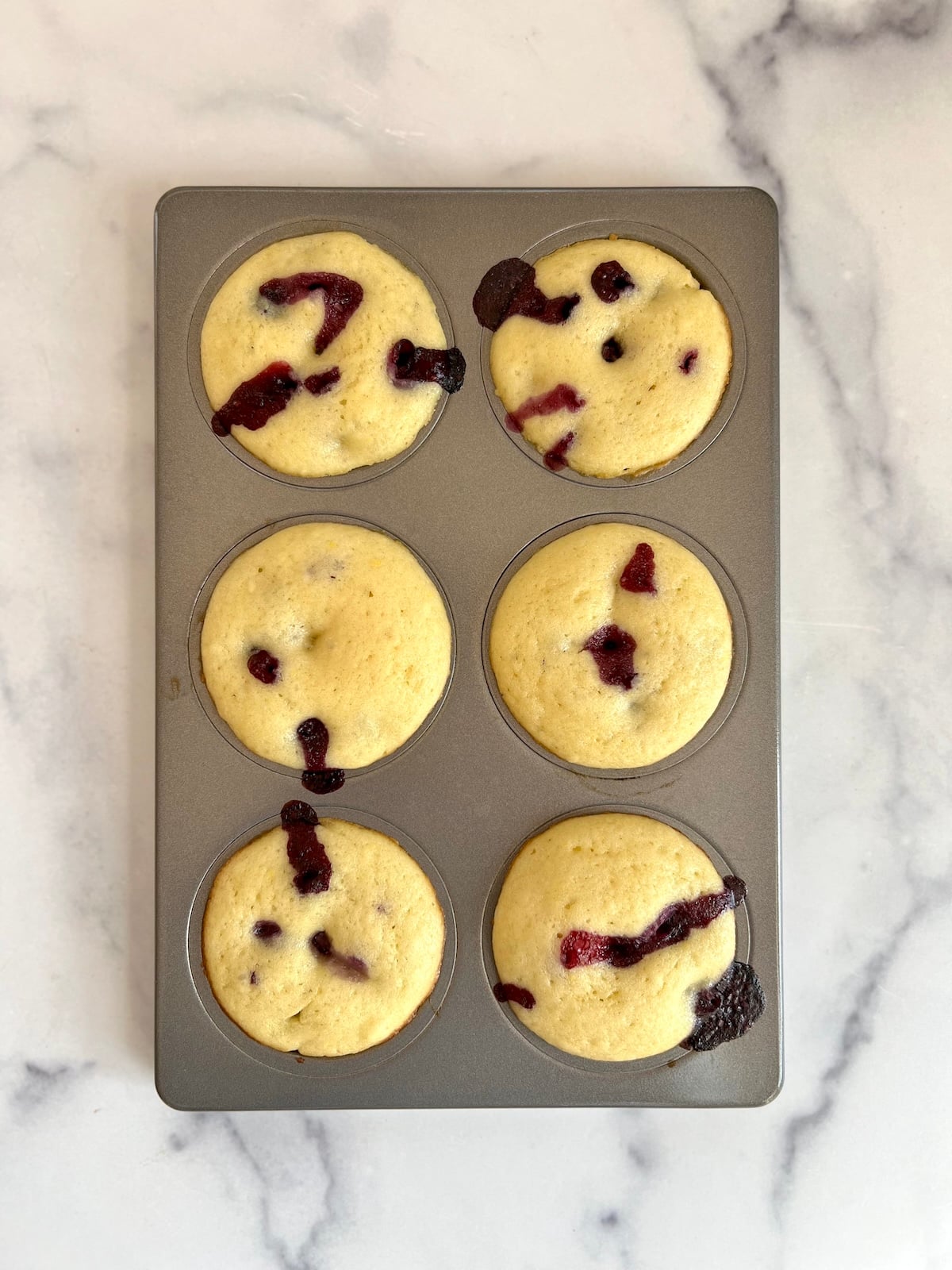 Baked blueberry doughnuts in doughnut pan.