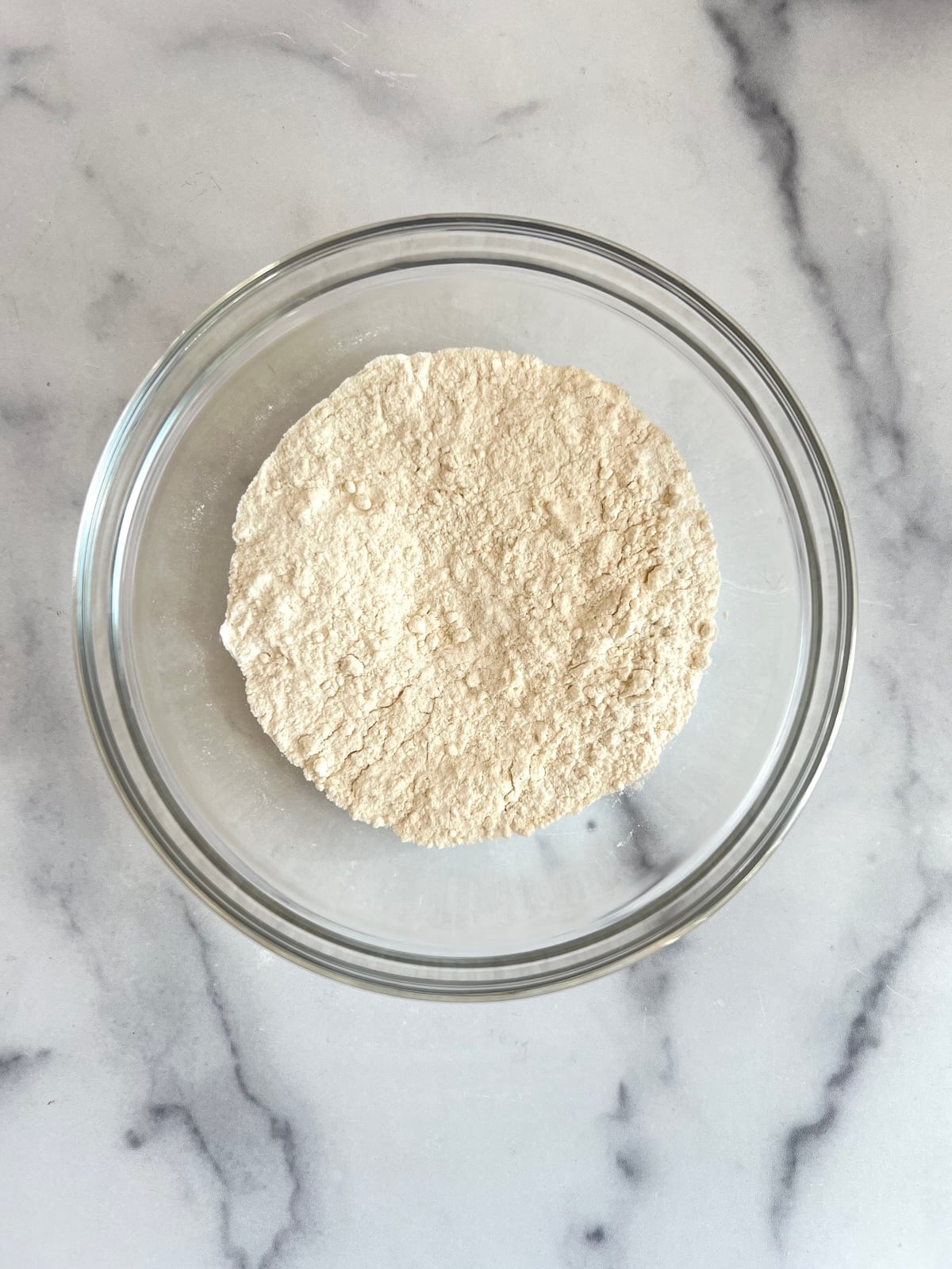 Baked blueberry doughnuts dry ingredients in a mixing bowl.