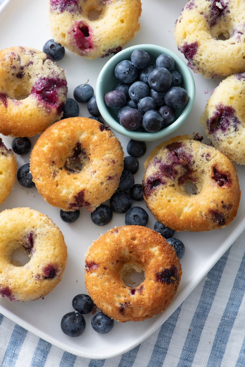 Baked blueberry doughnuts ona serving platter.