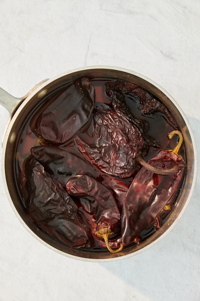 Dried Ancho and Guajillo Chiles soaking in water.