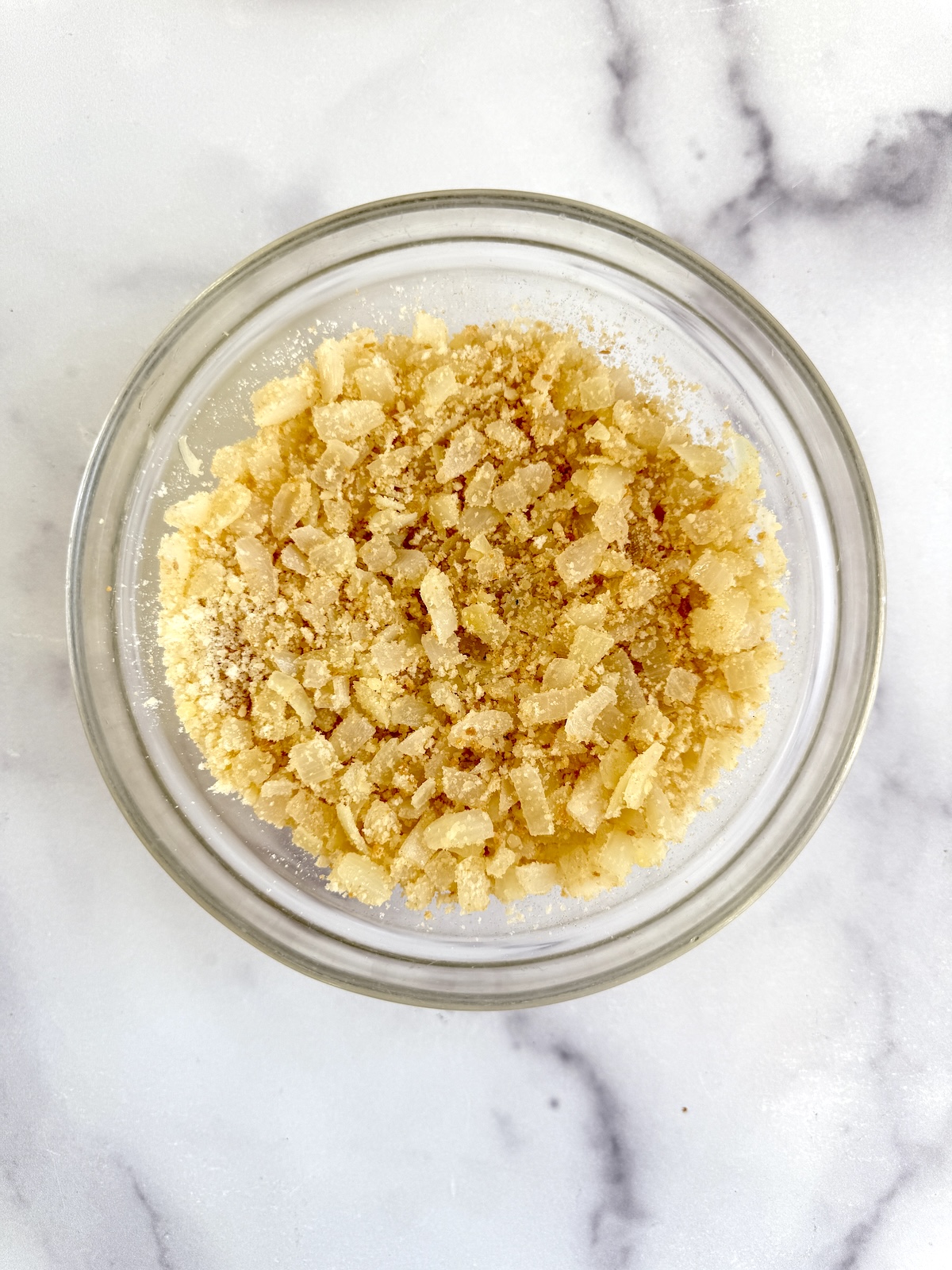 Onions, breadcrumbs and parmesan in a mixing bowl.