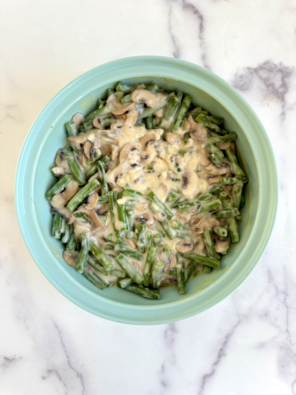 Green beans with mushroom sauce in a baking dish.