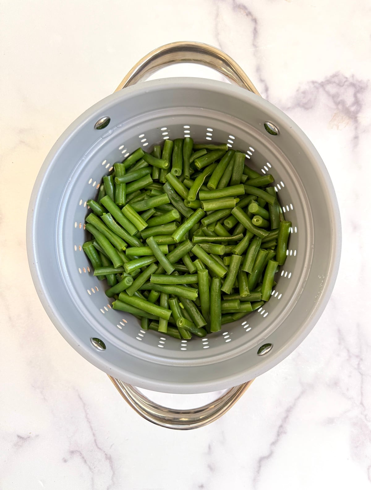 Green beans in a steamer pot.