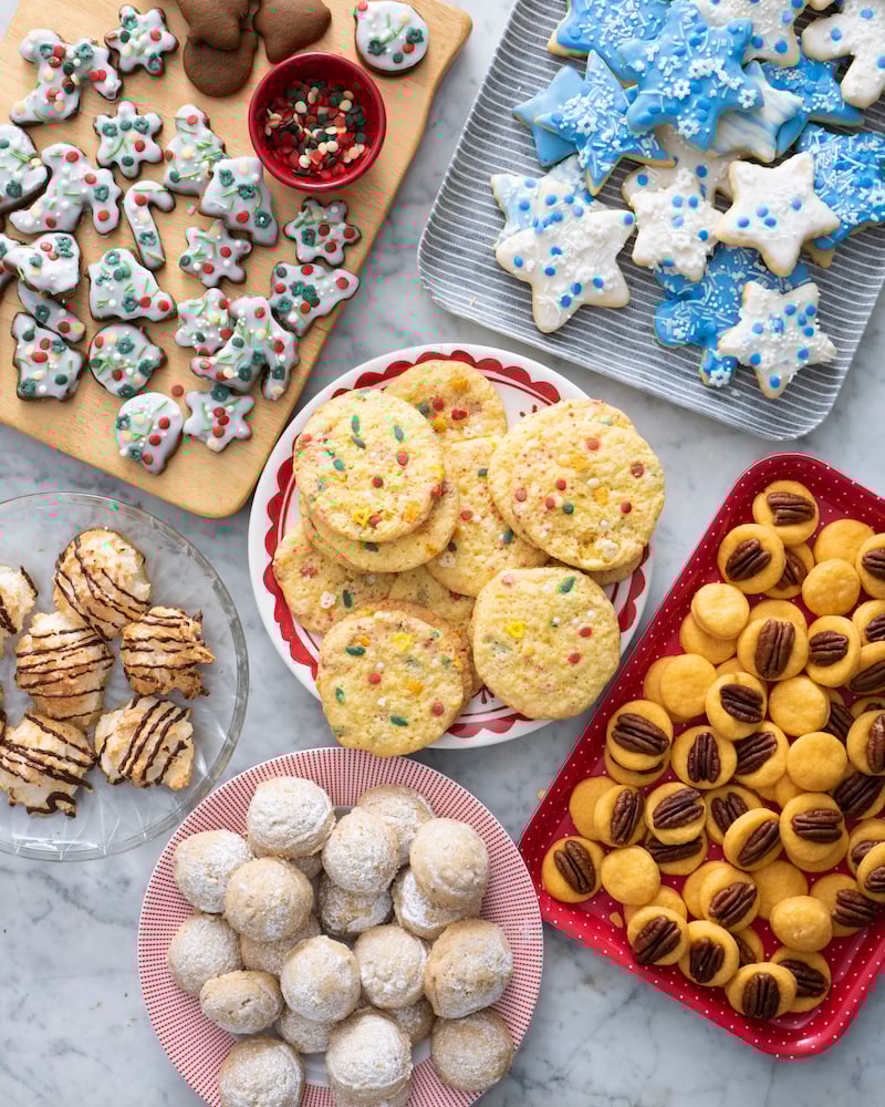Several Christmas cookie recipes on serving platters.
