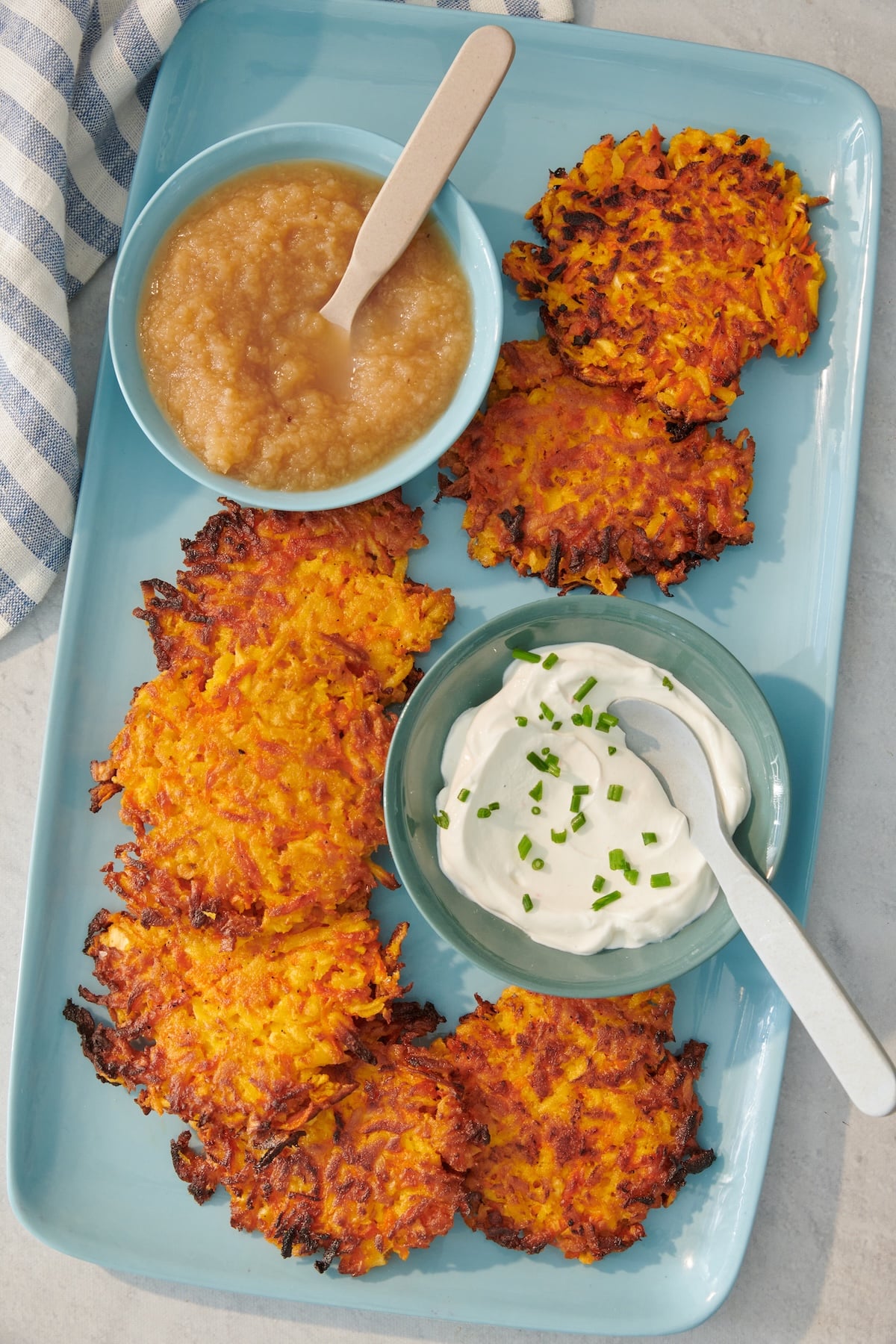 Carrot parsnip latkes served with applesauce and sour cream.