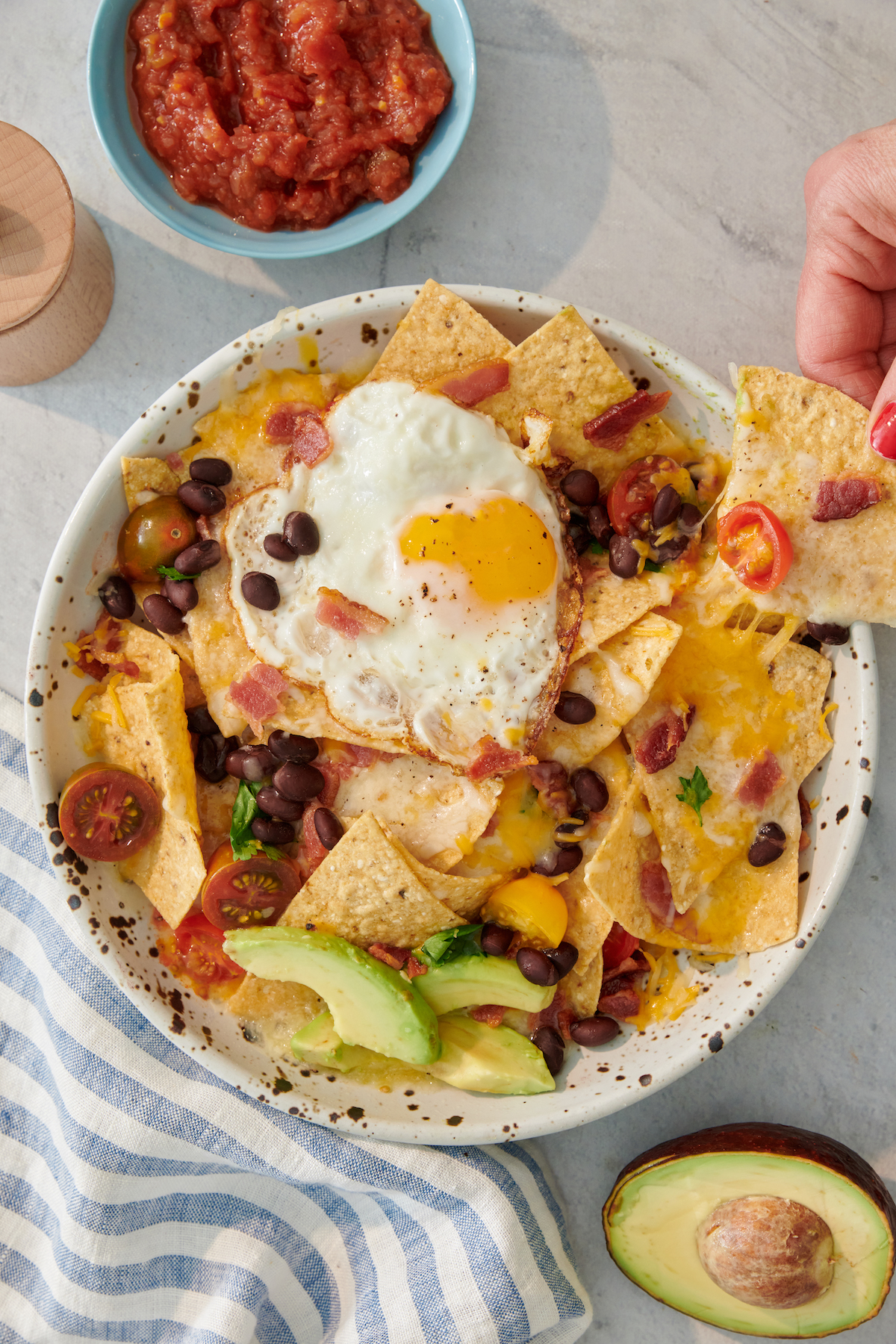 breakfast nachos on large plate with salsa on the side