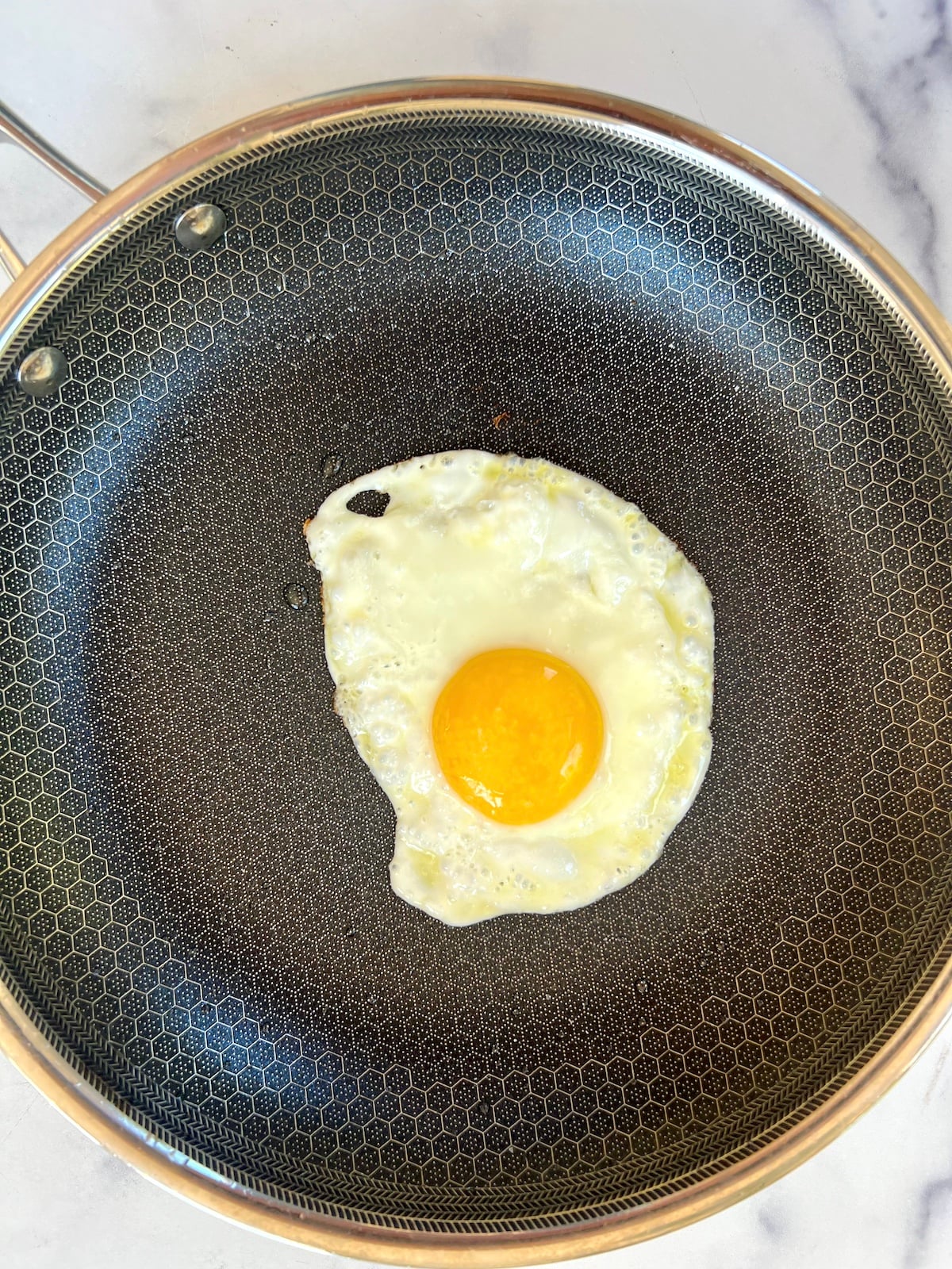 Fried egg in a pan.