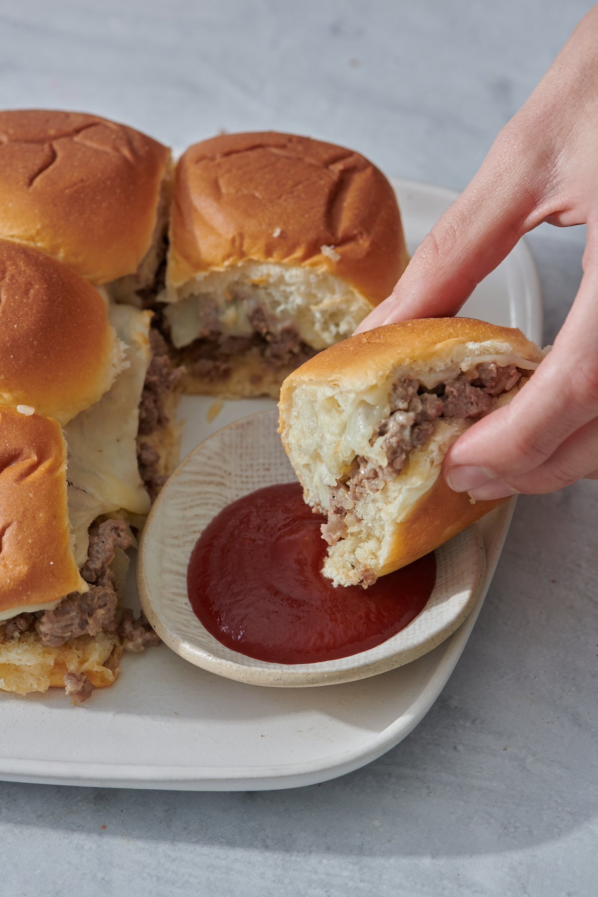 Dipping a slider in ketchup.