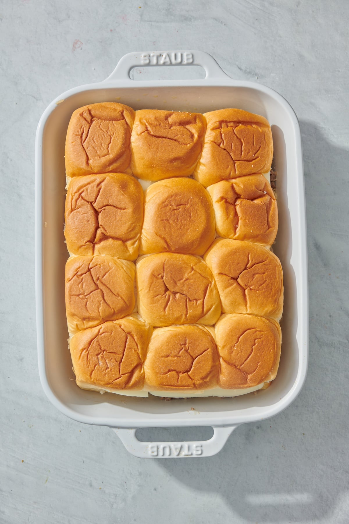 Easy cheeseburger sliders in a baking dish.