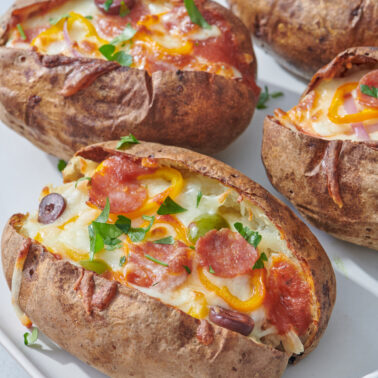 Pizza stuffed potatoes on a plate.