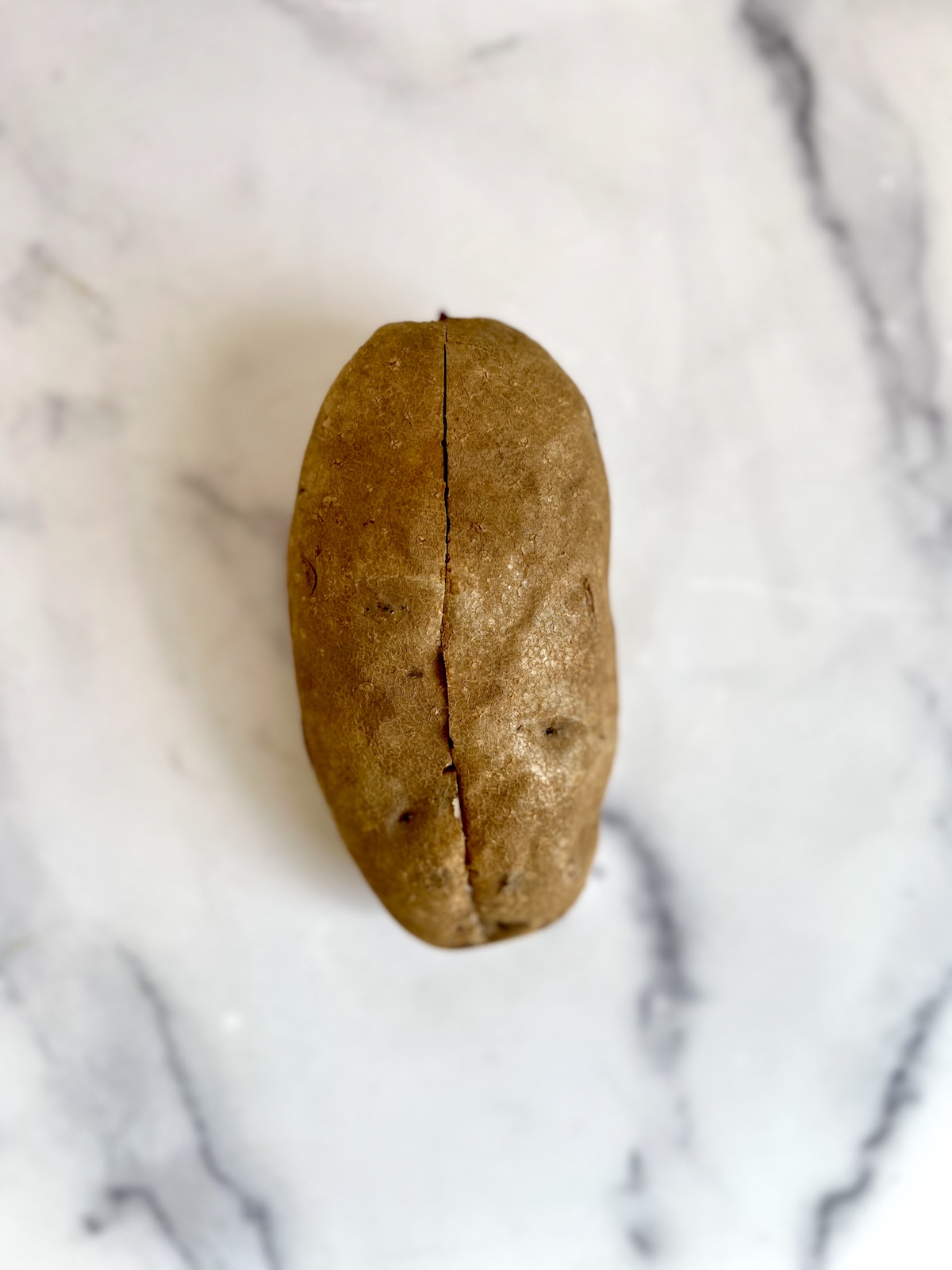 Baked potato sliced down the center.