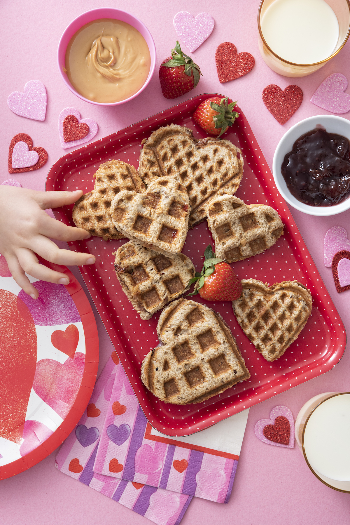 Waffle heart sandwiches on red platter.