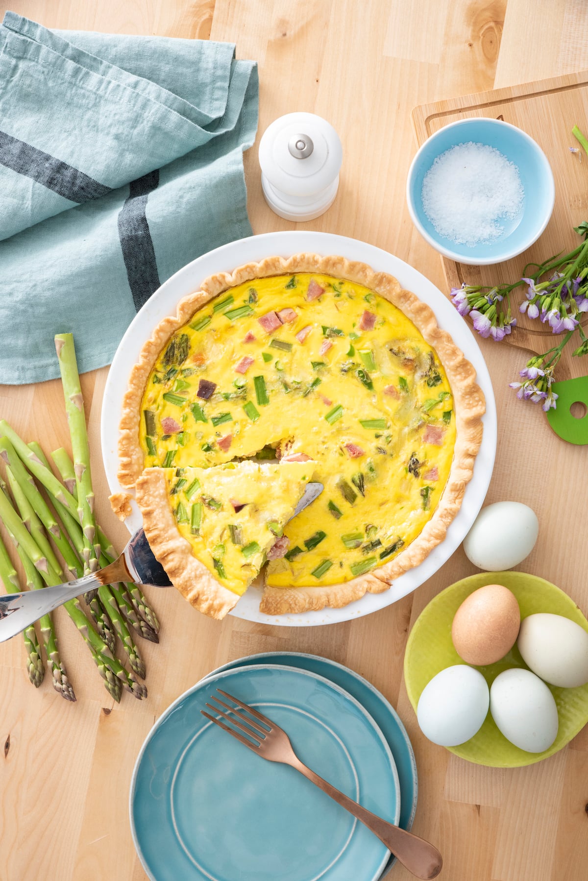Ham and Asparagus Quiche in a white pie plate. 