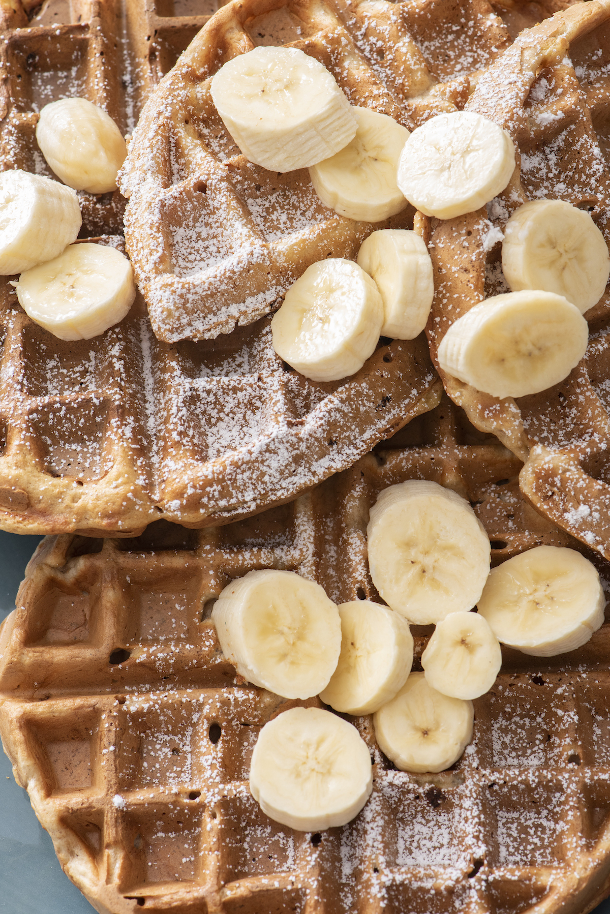 close up of waffles topped with banana slices