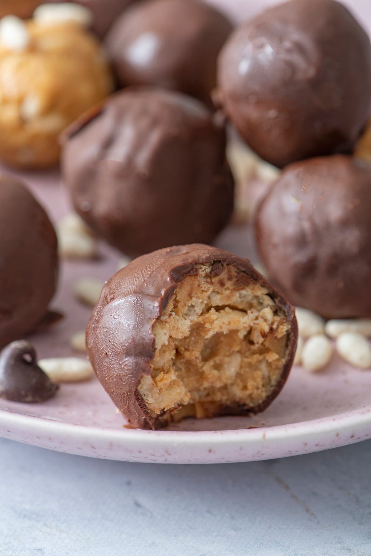 bite taken out of chocolate covered rice crispy ball