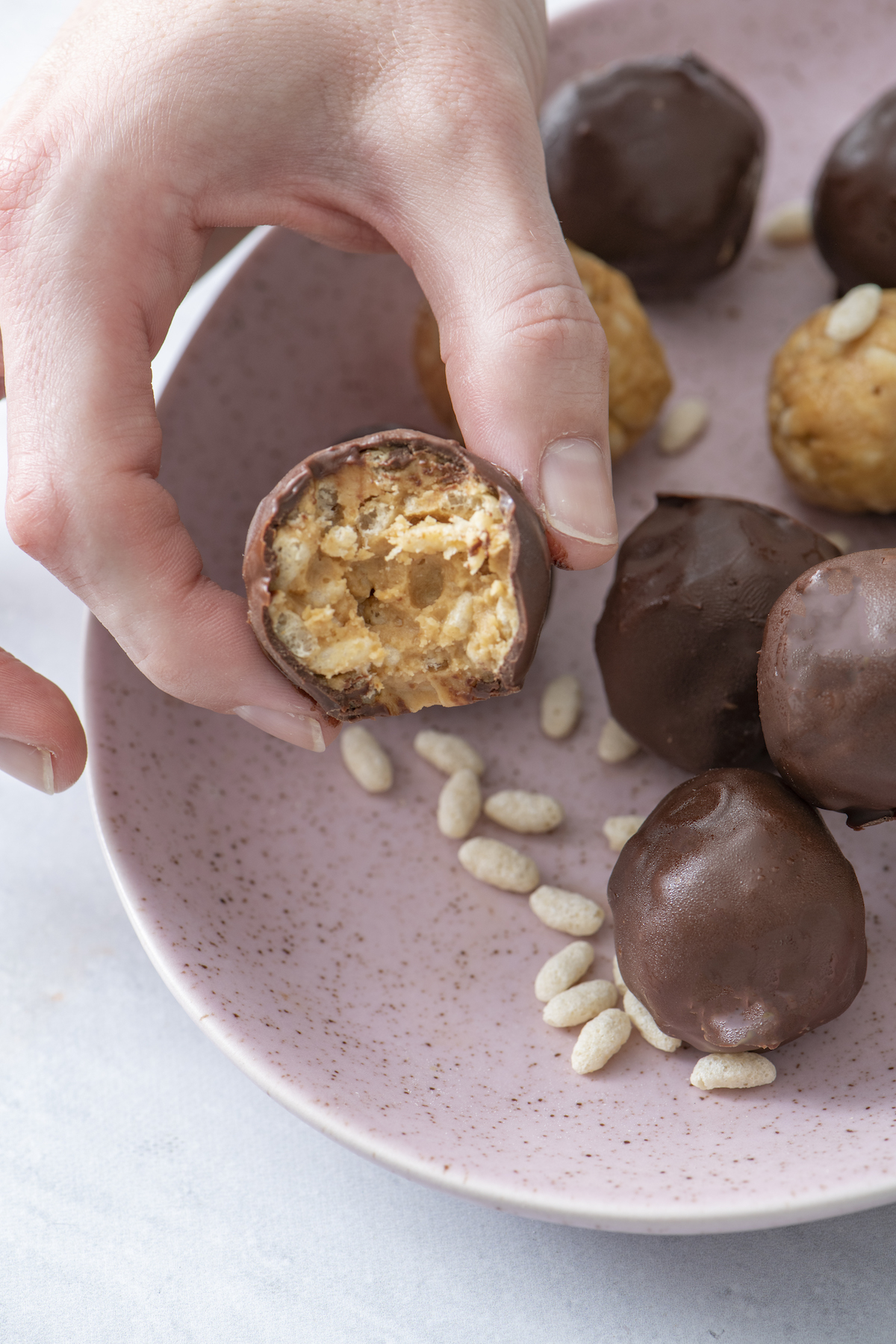 hand holding chocolate crispy rice bite