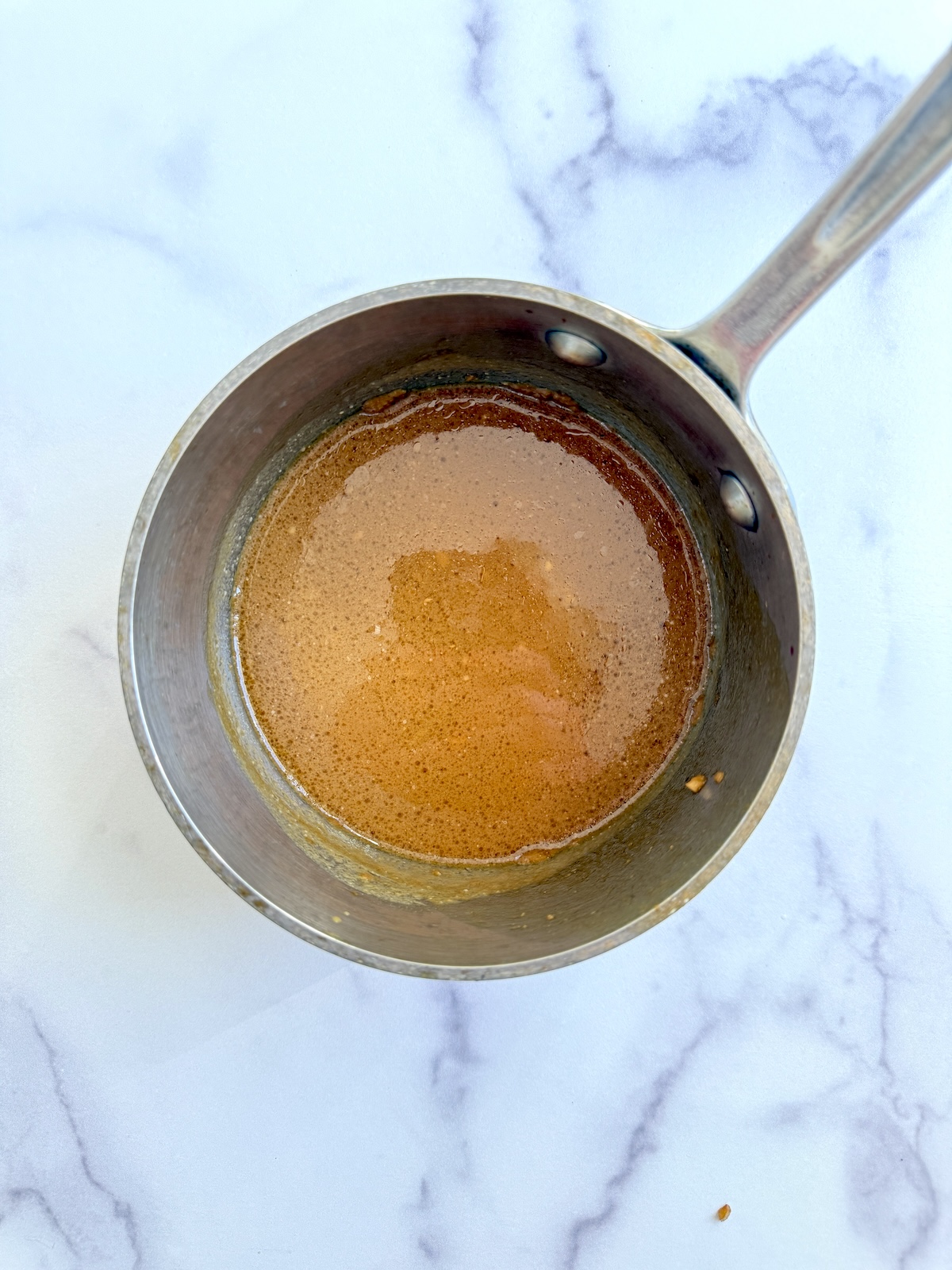 Marinade reducing in a sauce pan.