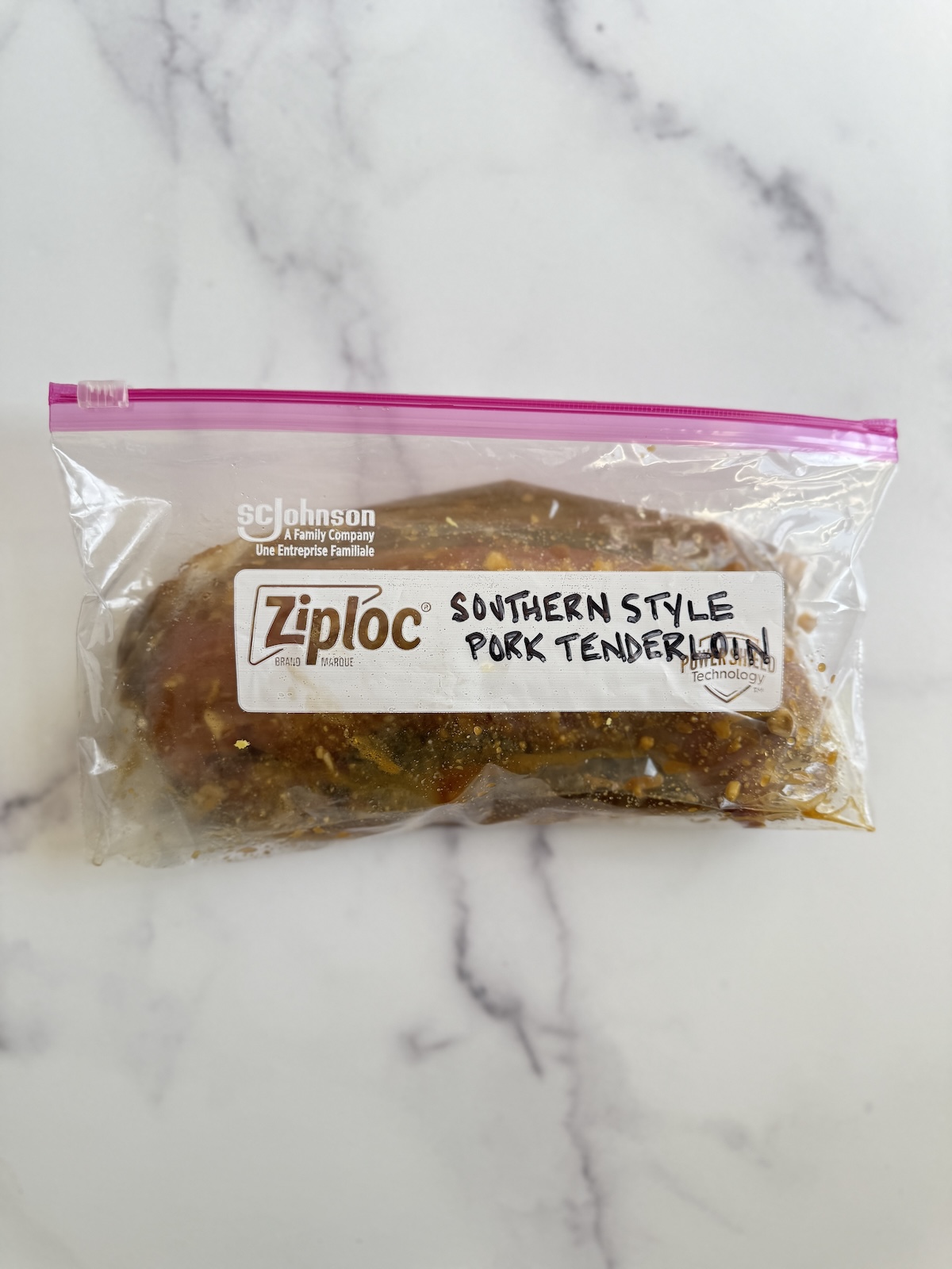 Pork tenderloin marinating in zipper bag.