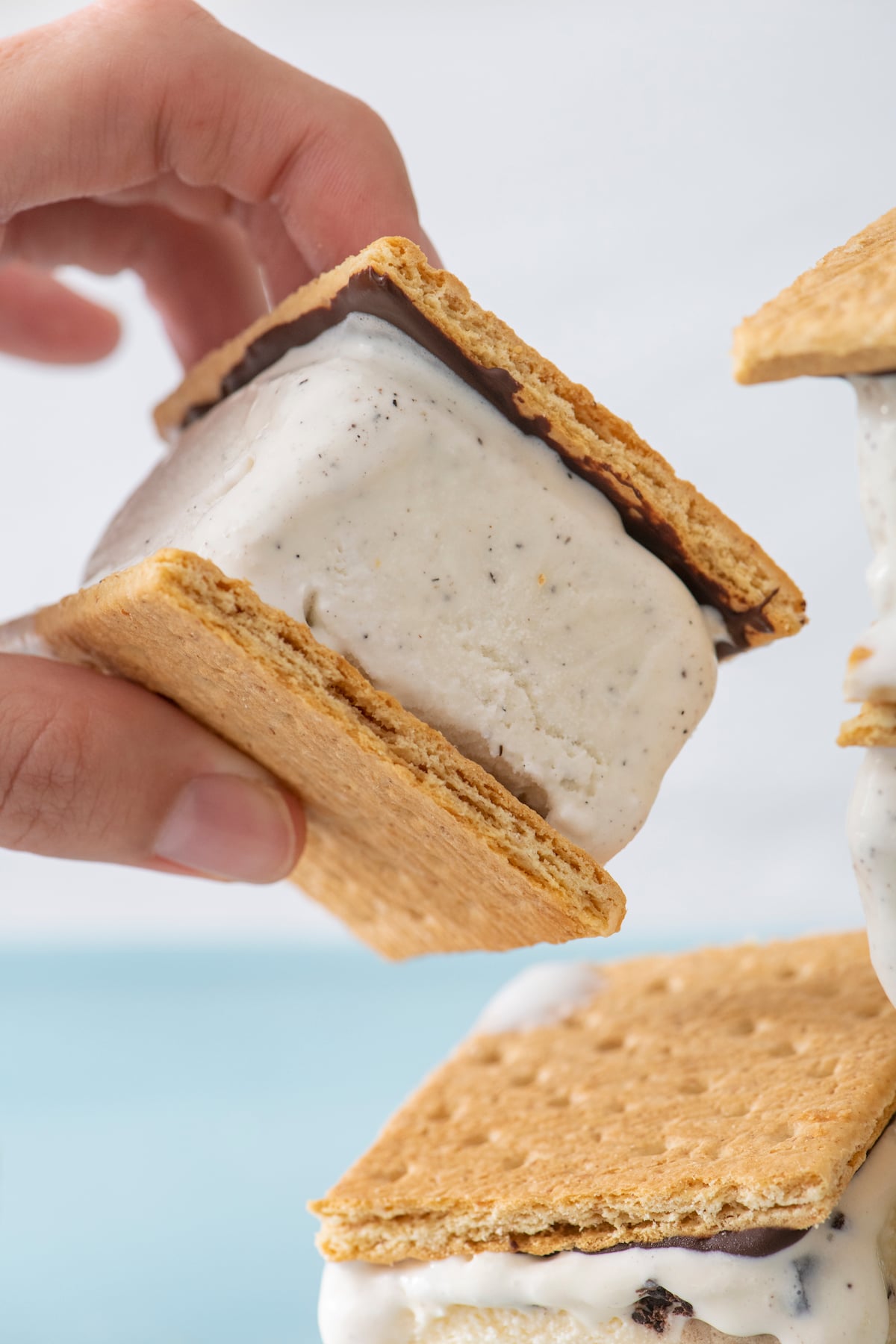 hand holding graham cracker ice cream sandwich