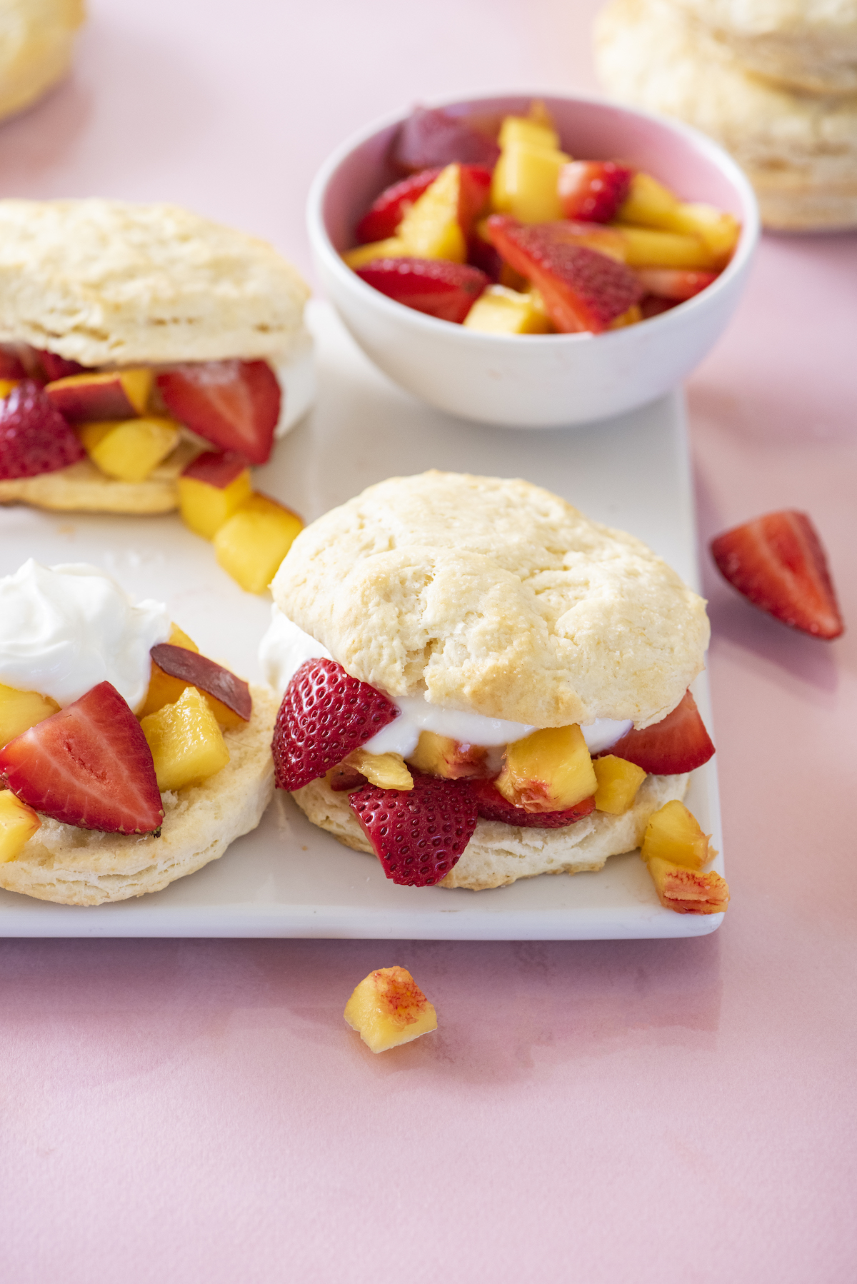 Peach and strawberry shortcakes on serving platter.