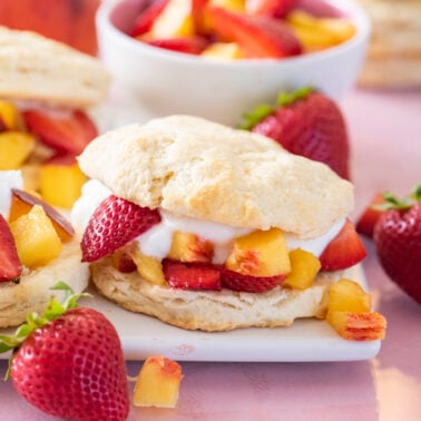 Peach and strawberry shortcakes on a platter.
