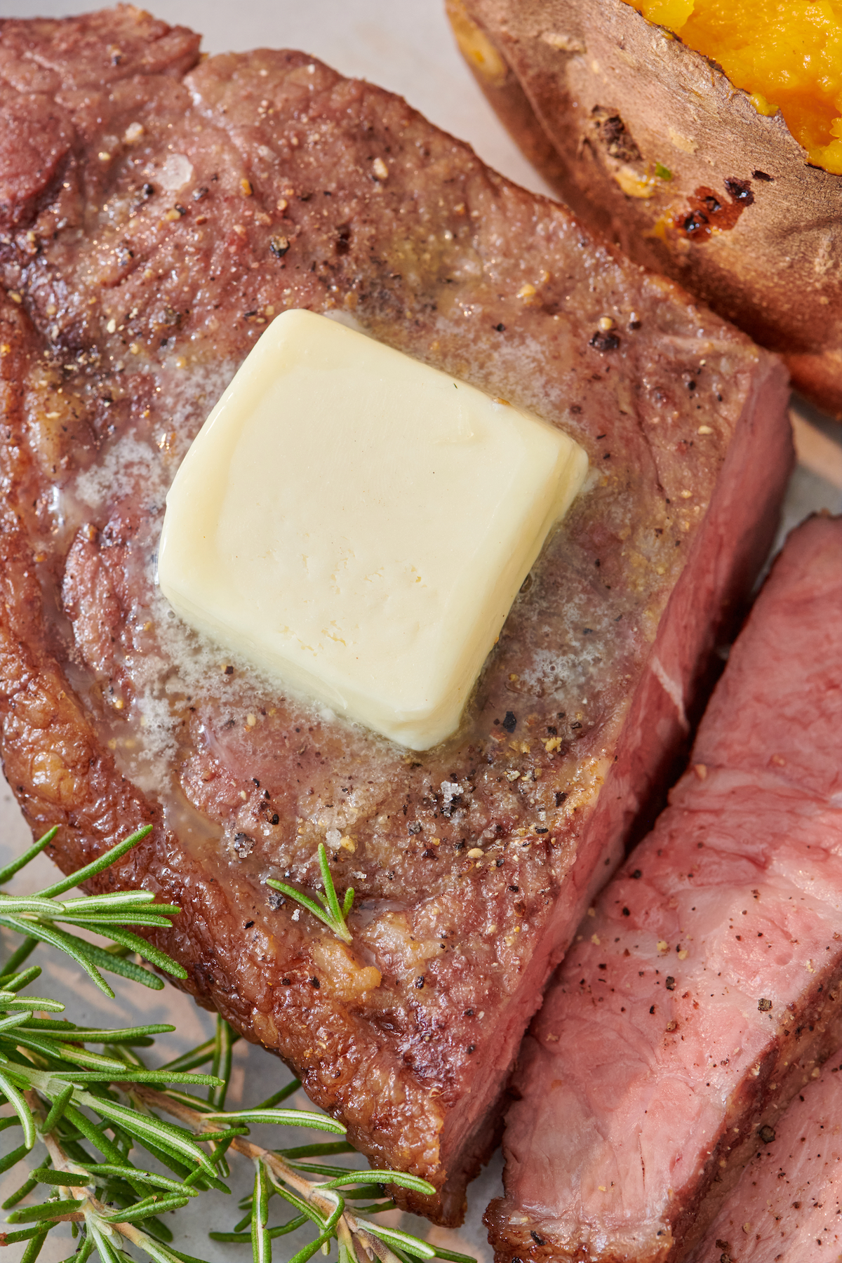 Close up of Air Fryer Steak topped with butter.