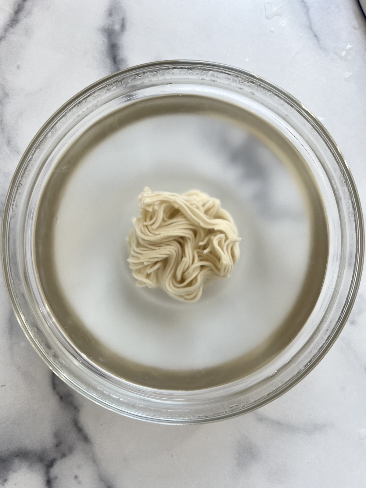 Ramen noodles sitting in hot water.