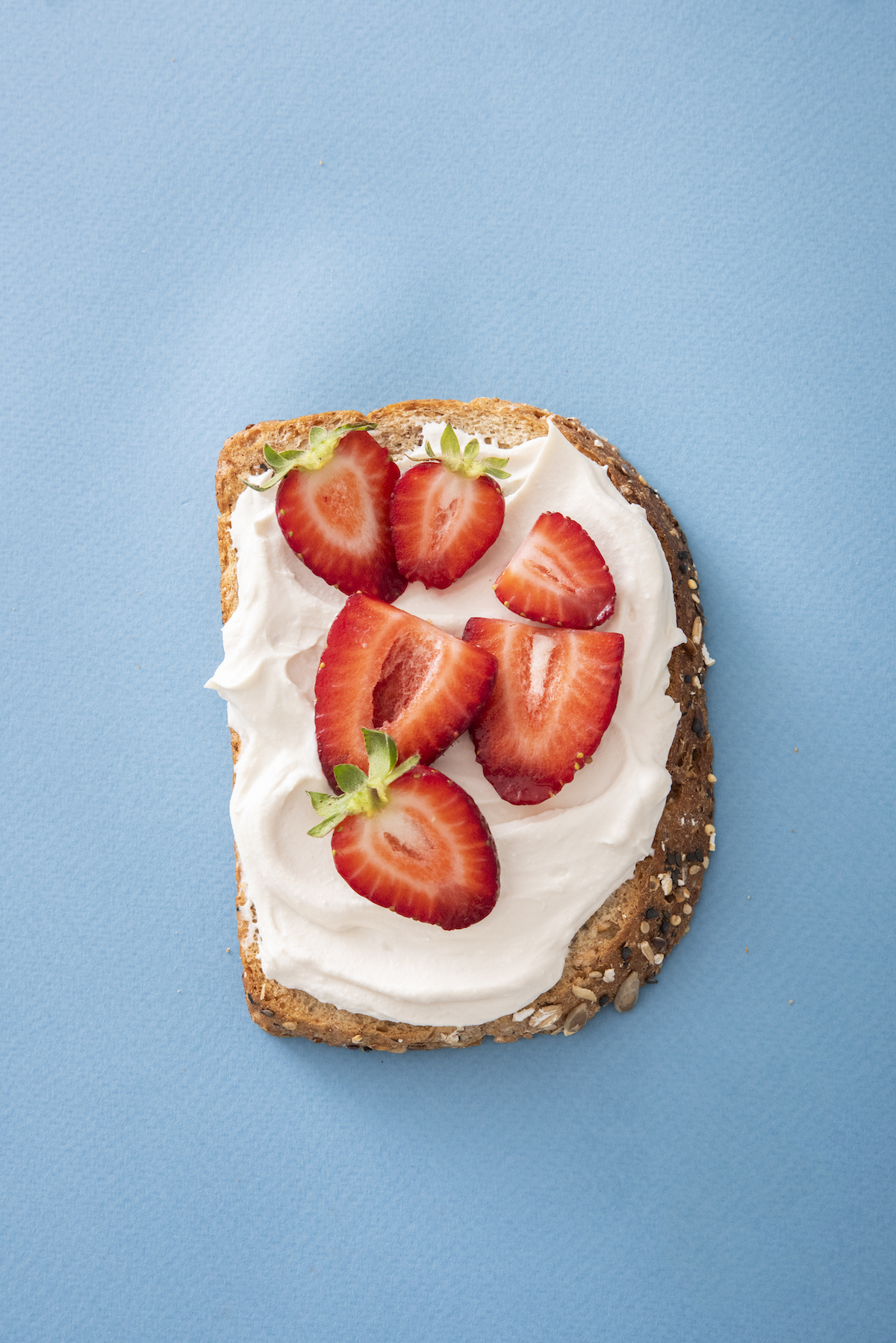 open faced sandwich with cream cheese and strawberries