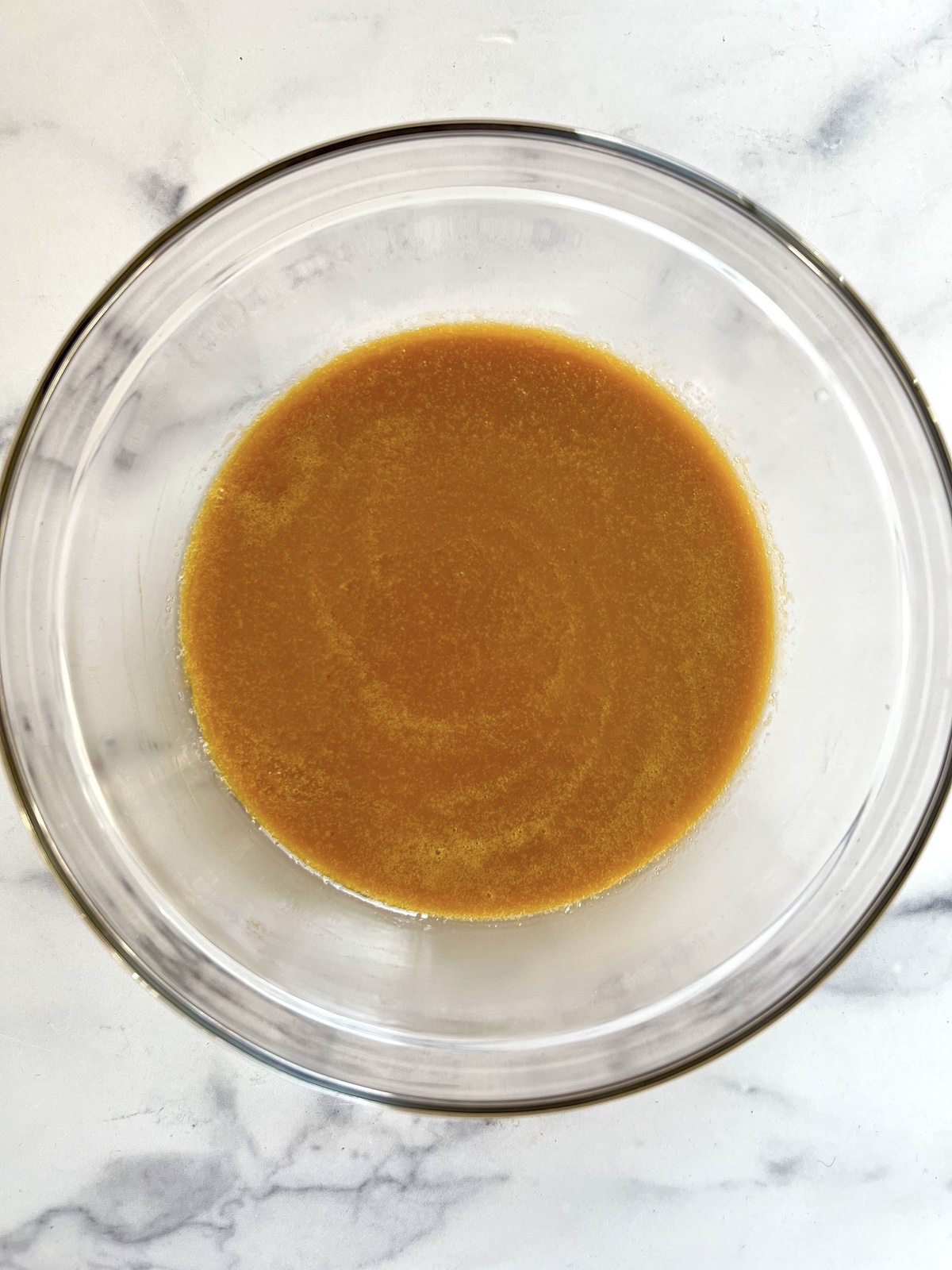 Pumpkin muffins wet ingredients in mixing bowl.