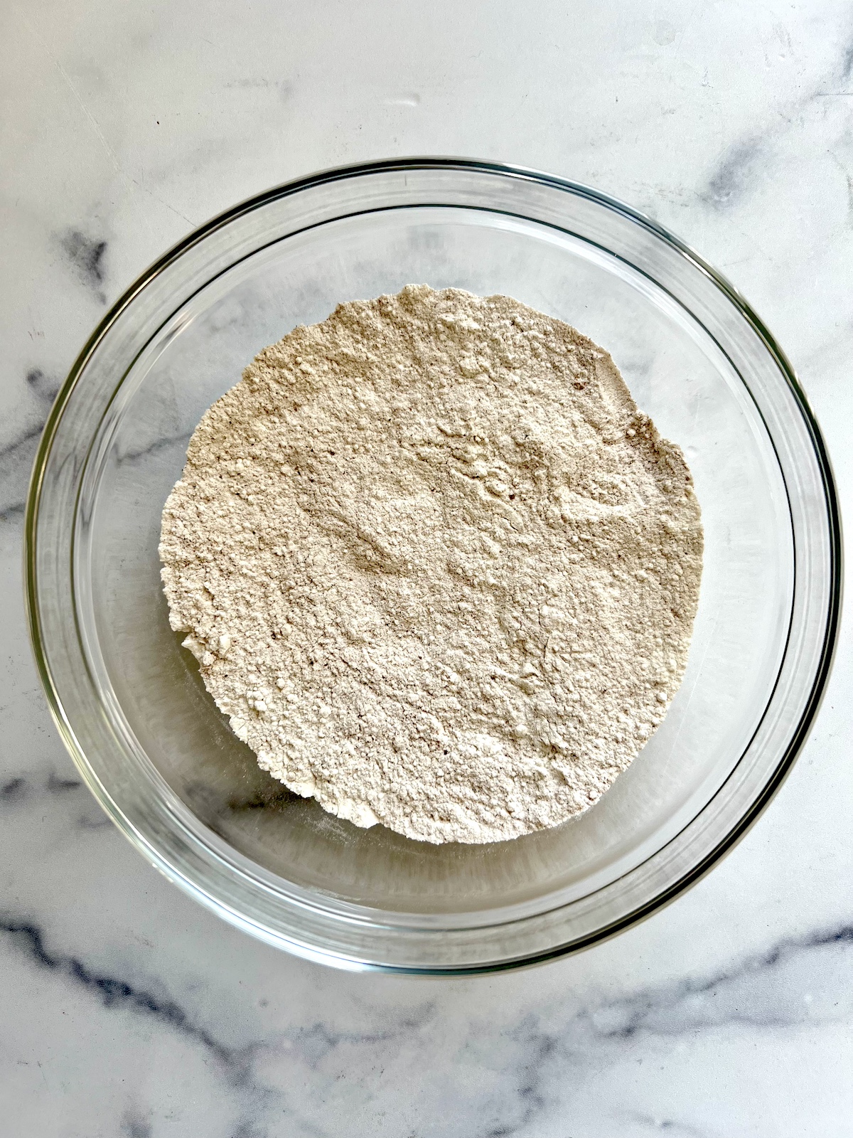 Pumpkin muffin dry ingredients in a mixing bowl.