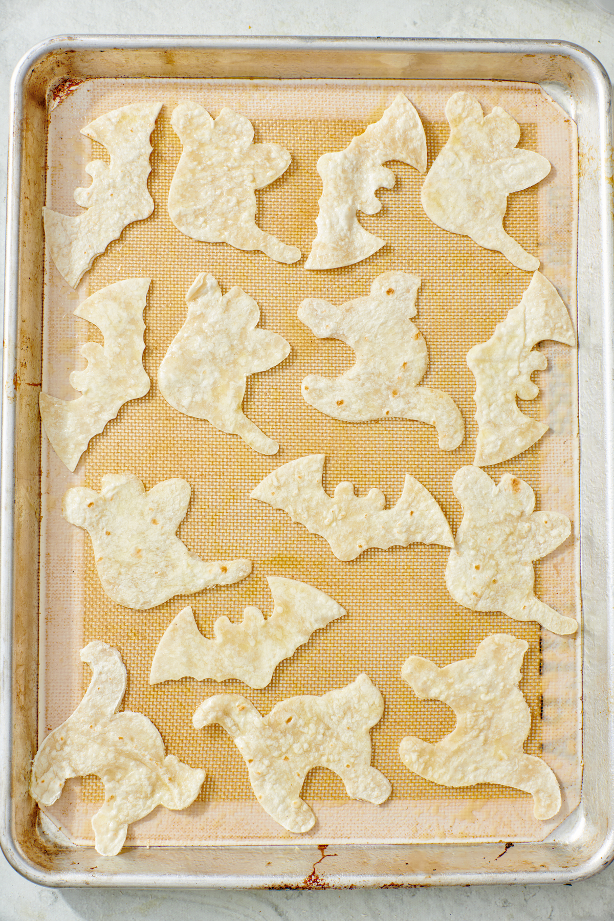Halloween tortillas on baking sheet.