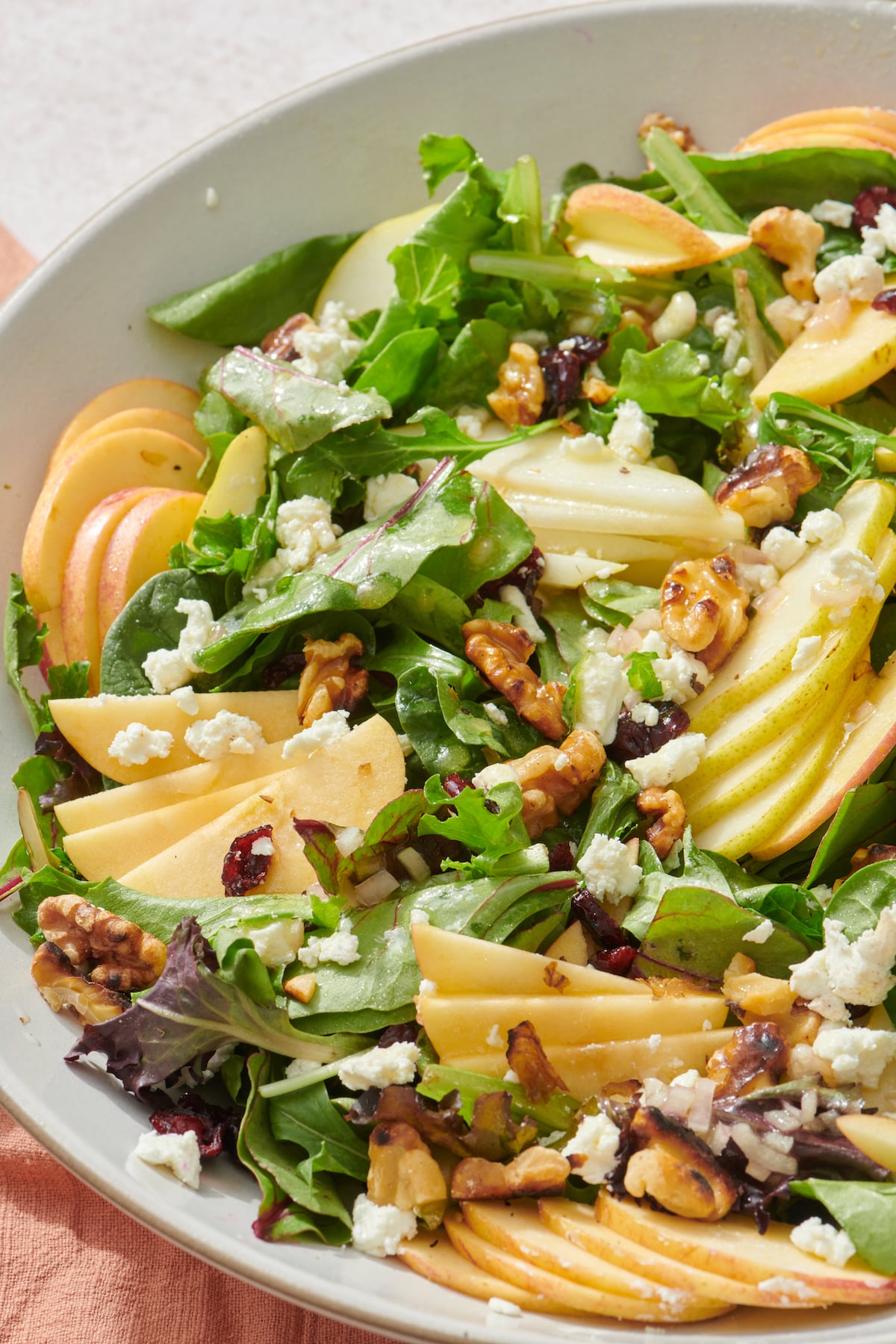 Salad topped with apples, pears and goat cheese.