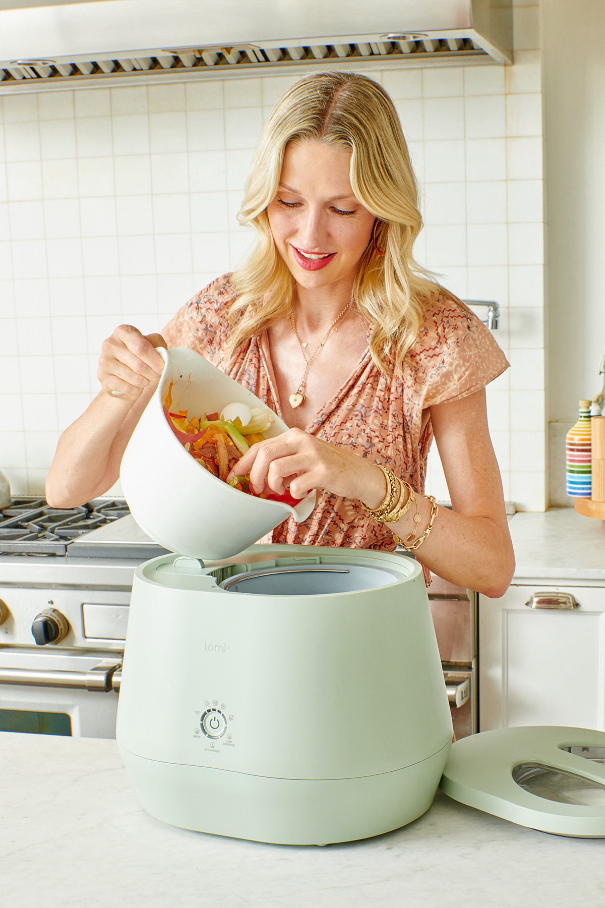 Catherine McCord adding food waste to her Lomi device.