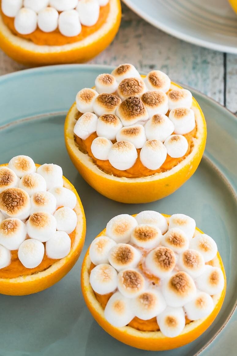 Sweet Potatoes In Orange Cups on blue plate.
