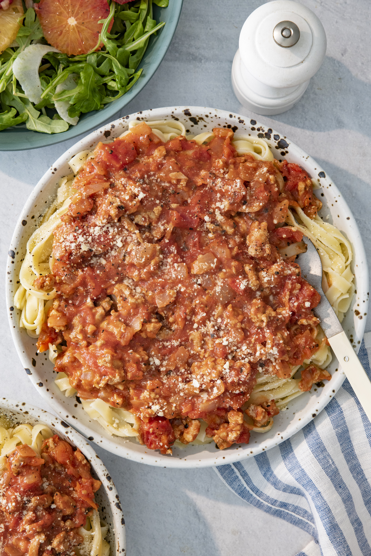 Overhead of serving platter with turkey bolognese over fettuccine.