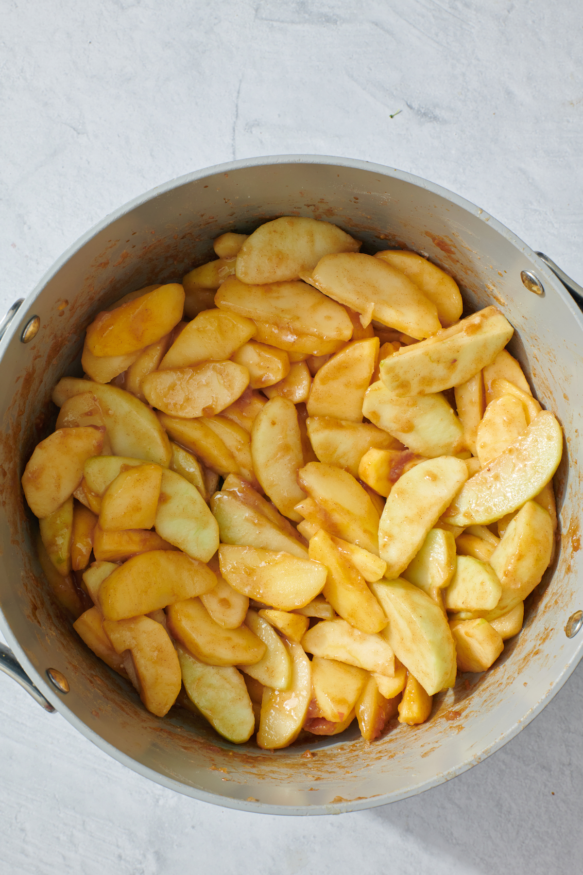 Cooked apple slices in a pot.